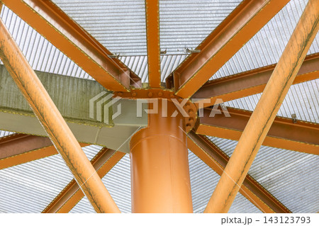 Orange metal roof support structure with steel beams Orange metal roof support structure with steel beams 143123793