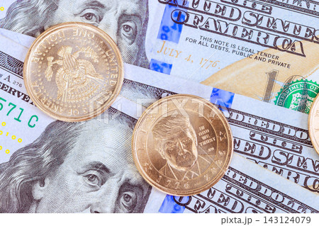4 JULY 2026 Washington DC US Currency US 100 dollars and several Trump dollar coins displayed together for United States 250th Anniversary celebration. 4 JULY 2026 Washington DC US Currency US 100 dollars and several Trump dollar coins displayed together for United States 250th Anniversary celebration. 143124079