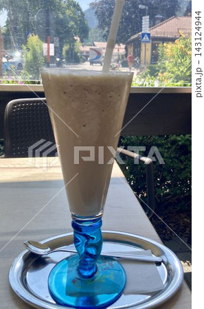 Iced coffee latte drink in a glass on a cafe table in Mittenwald, Bavaria, Germany 143124944