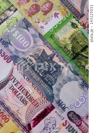 Guyana paper money, dollar banknotes and coins as currency for exchange or travel Guyana paper money, dollar banknotes and coins as currency for exchange or travel 143125031