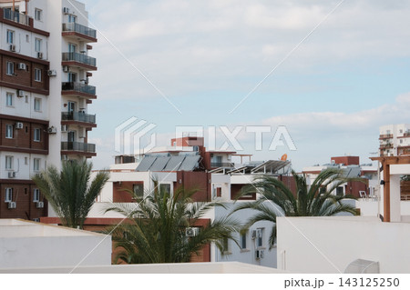 Solar water heaters and panels on rooftops of modern residential buildings in Cyprus, eco friendly energy in resort city Solar water heaters and panels on rooftops of modern residential buildings in Cyprus, eco friendly energy in resort city 143125250