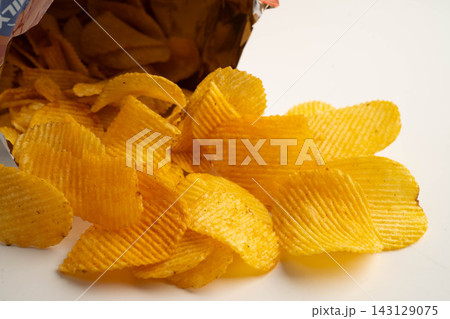 Potato chips , delicious BBQ seasoning spicy for crips, thin slice deep fried snack fast food. Potato chips , delicious BBQ seasoning spicy for crips, thin slice deep fried snack fast food. 143129075