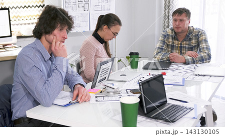 Awaiting dismissal. A group of young people are sitting at a table in a conference room and are seriously thinking about something Awaiting dismissal. A group of young people are sitting at a table in a conference room and are seriously thinking about something 143130105