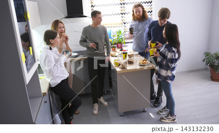 Coffee break at work. The scene is relaxed and social, as a group of friends enjoy each other's company, sharing food and drinks Coffee break at work. The scene is relaxed and social, as a group of friends enjoy each other's company, sharing food and drinks 143132230