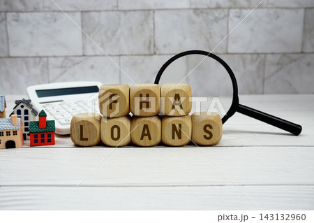 FHA Loans alphabet letters with house model, calculator and magnifying glass 143132960