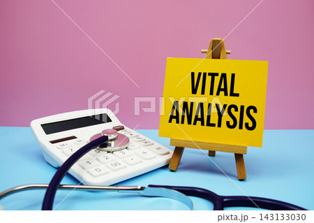 Vital Analysis text with stethoscope and calculator on pink and blue background 143133030