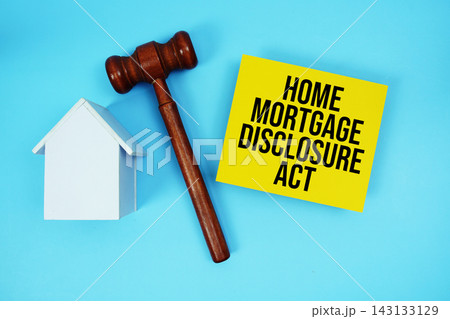 Home Mortgage Disclosure Act text with judgment gavel and house model on blue background 143133129