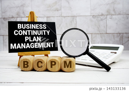 BCPM Business Continuity Plan Management text with calculator magnifying glass and on wooden background BCPM Business Continuity Plan Management text with calculator magnifying glass and on wooden background 143133136