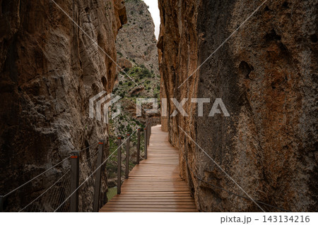 ooden boardwalk clinging to sheer canyon walls at Caminito del Rey, Spain ooden boardwalk clinging to sheer canyon walls at Caminito del Rey, Spain 143134216