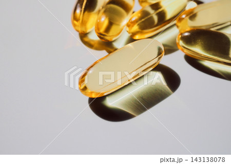 Golden omega-3 gel capsules showing essential healthy supplements for wellness Golden omega-3 gel capsules showing essential healthy supplements for wellness 143138078