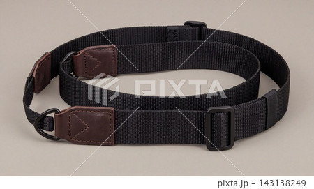 Black adjustable camera neck strap with leather reinforced ends accessory photography adjustable equipment fastener attachment professional photographer fastening hardware material 143138249