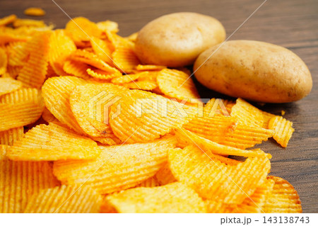 Potato chips , delicious BBQ seasoning spicy for crips, thin slice deep fried snack fast food. 143138743