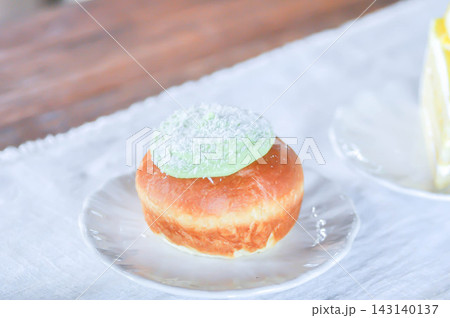 brioche donut or doughnut or bun with green tea dressing or pandan custard and Coconut flakes topping brioche donut or doughnut or bun with green tea dressing or pandan custard and Coconut flakes topping 143140137
