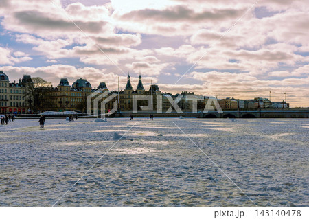 People walking on frozen lake during blue hour in Copenhagen winter evening. Copenhagen, Denmark 143140478
