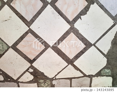 Old white and pink diamond patterned floor tiles with grunge texture. Old white and pink diamond patterned floor tiles with grunge texture. 143143895