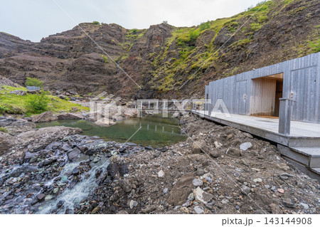 Natural hot spring pool near Husafell in Iceland 143144908
