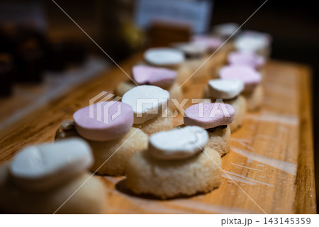 Dessert canapes on wooden board with pastel disks in the Maldives Dessert canapes on wooden board with pastel disks in the Maldives 143145359