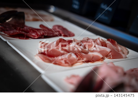 Prosciutto and salumi on white platters at San Domenico ski resort 143145475