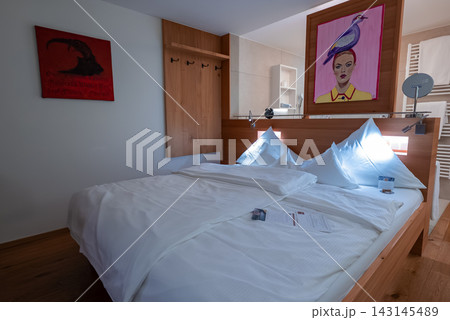 Modern hotel room in Oberlech, Austria with double bed and art 143145489