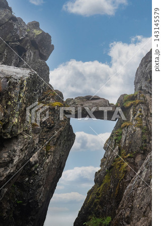 Natural stone bridge wedged between cliffs in Lofoten, Norway 143145579