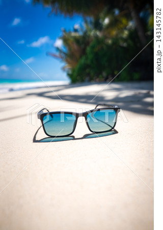 Sunglasses Rest on White Sand of a Maldives Beach Sunglasses Rest on White Sand of a Maldives Beach 143145782