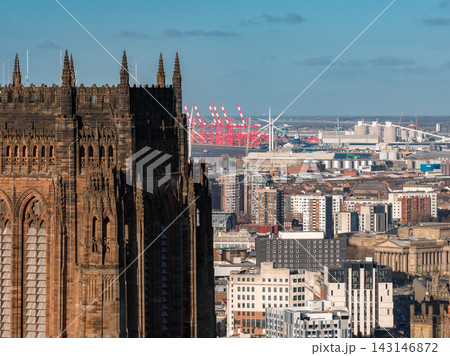 Liverpool at sunrise shows Liverpool Cathedral, St George's Hall, River Mersey docks with red container cranes and wind turbines, crisp light, and modern high rises. Liverpool at sunrise shows Liverpool Cathedral, St George's Hall, River Mersey docks with red container cranes and wind turbines, crisp light, and modern high rises. 143146872