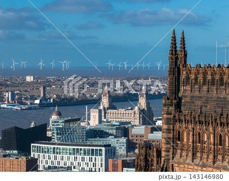 Aerial sunrise view of Liverpool with Liverpool Cathedral at right, the River Mersey across middle, the Three Graces and Royal Liver Building, and offshore wind turbines. Aerial sunrise view of Liverpool with Liverpool Cathedral at right, the River Mersey across middle, the Three Graces and Royal Liver Building, and offshore wind turbines. 143146980