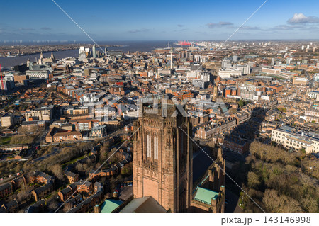 Aerial sunrise view of Liverpool centers on Liverpool Cathedral, with River Mersey, Three Graces, Radio City Tower, Port cranes, and offshore wind turbines visible. Aerial sunrise view of Liverpool centers on Liverpool Cathedral, with River Mersey, Three Graces, Radio City Tower, Port cranes, and offshore wind turbines visible. 143146998