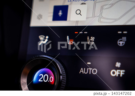 Close up interior shows Lexus RX 450h plus climate controls, digital dial at 20.0 C, icons for defrost, heated and ventilated seats, heated wheel, and nav bar in low light. Close up interior shows Lexus RX 450h plus climate controls, digital dial at 20.0 C, icons for defrost, heated and ventilated seats, heated wheel, and nav bar in low light. 143147202
