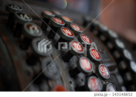 Vintage rows of raised keys marked 11F, 12, 14, and 15 sit in low light, worn metal in view. 143148652
