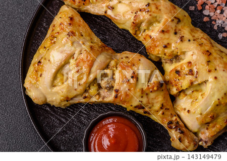 Grilled chicken quarter seasoned with mustard, spices, and salt. Grilled chicken leg Grilled chicken quarter seasoned with mustard, spices, and salt. Grilled chicken leg 143149479