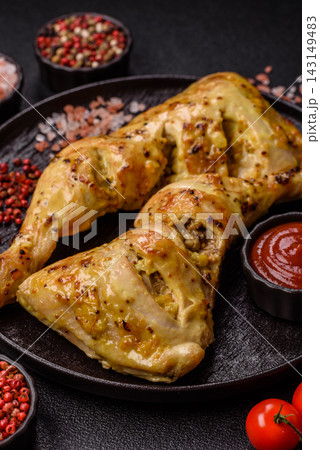 Grilled chicken quarter seasoned with mustard, spices, and salt. Grilled chicken leg 143149483