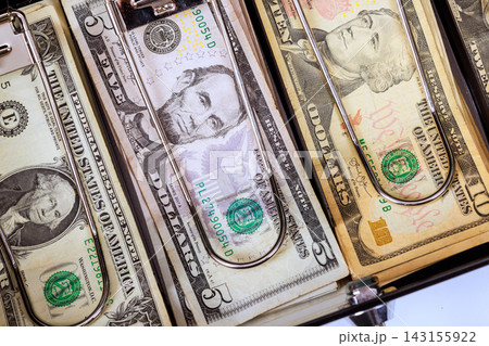 American dollar cash banknotes are arranged inside cashier drawer. American dollar cash banknotes are arranged inside cashier drawer. 143155922