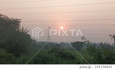 Power transmission pylon silhouette against a peaceful evening horizon Power transmission pylon silhouette against a peaceful evening horizon 143156645