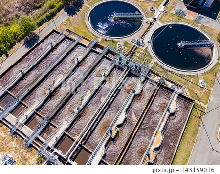 Water treatment facility with large tanks and filtration systems in operation during daylight hours 143159016