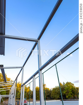 Structure with metal frames under clear sky during day in a park area Structure with metal frames under clear sky during day in a park area 143159050