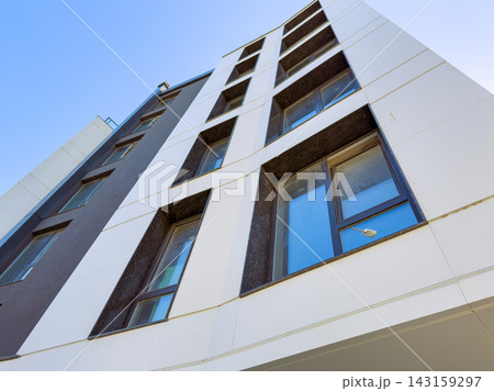 Modern building with unique design and windows under clear sky 143159297