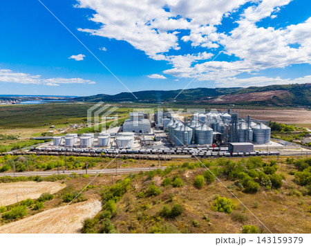 Industrial site with grain silos and storage facility in a rural area during the day Industrial site with grain silos and storage facility in a rural area during the day 143159379
