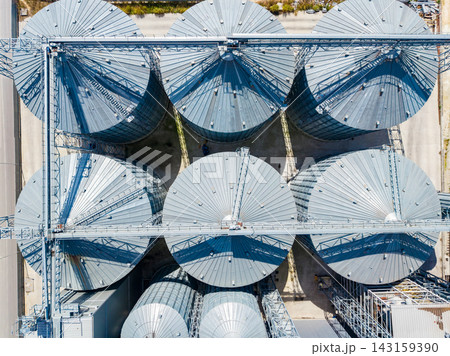 View of grain silos in a storage facility in an industrial area during daylight View of grain silos in a storage facility in an industrial area during daylight 143159390