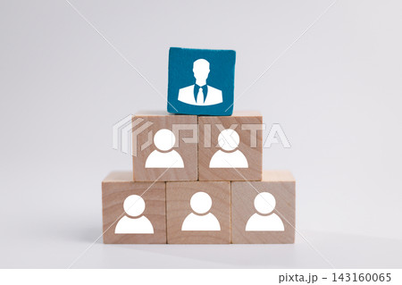Wooden blocks form a hierarchy with employee icons and a blue executive block on top, representing leadership, management, organization, team structure, authority, promotion, and business success. Wooden blocks form a hierarchy with employee icons and a blue executive block on top, representing leadership, management, organization, team structure, authority, promotion, and business success. 143160065