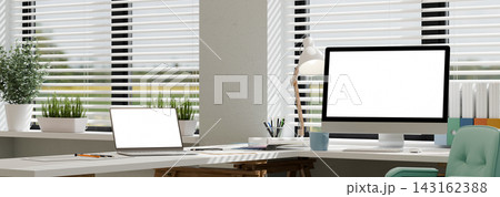 3D Illustration of Modern Home Office Workspace with Laptop and Desktop Computer Mockup on White Desk 3D Illustration of Modern Home Office Workspace with Laptop and Desktop Computer Mockup on White Desk 143162388