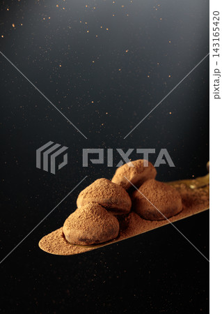 Chocolate truffles on a vintage brass cake server. Chocolate truffles on a vintage brass cake server. 143165420
