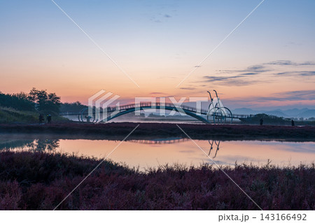 Sunrise Dawn over Misaeng Bridge with Water Reflection in Siheung Wetland, South Korea 143166492