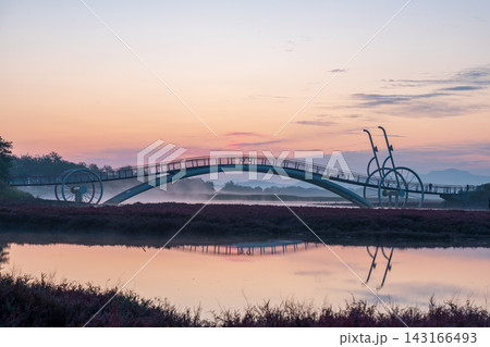 Sunrise Dawn over Misaeng Bridge with Water Reflection in Siheung Wetland, South Korea 143166493