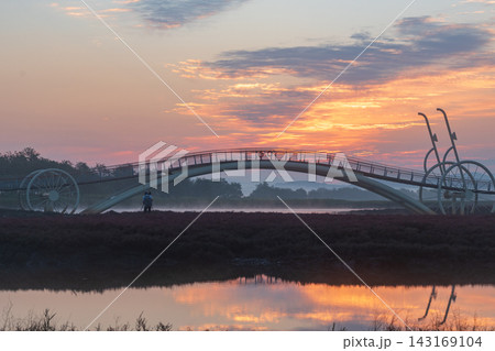 Sunrise Dawn over Misaeng Bridge with Water Reflection in Siheung Wetland, South Korea 143169104