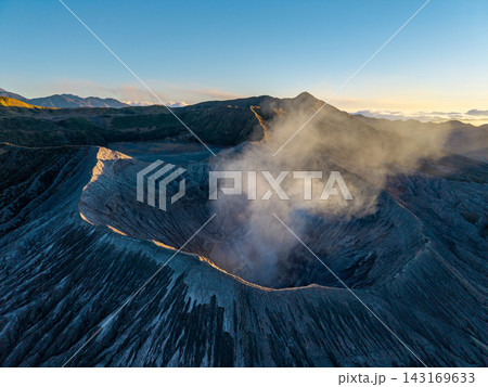 Vast volcanic crater glows under morning light Vast volcanic crater glows under morning light 143169633