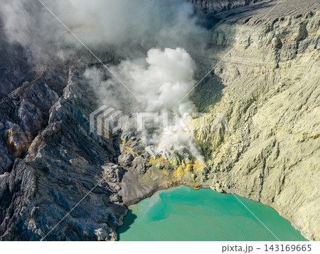 Mist curls gently from the jagged, volcanic rim Mist curls gently from the jagged, volcanic rim 143169665
