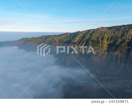 Misty valley stretches beneath sunlit hills Misty valley stretches beneath sunlit hills 143169671