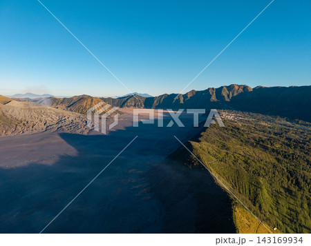 Cinematic landscape barren black sand plains at the foot of Mount Bromo volcano. 143169934