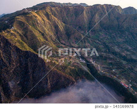 Golden light drapes mountain ridgelines Golden light drapes mountain ridgelines 143169978